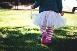 child wearing tutu and striped socks
