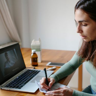 Woman using a laptop for a telehealth visit.