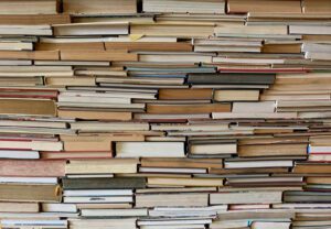 A large stack of books in an archive.